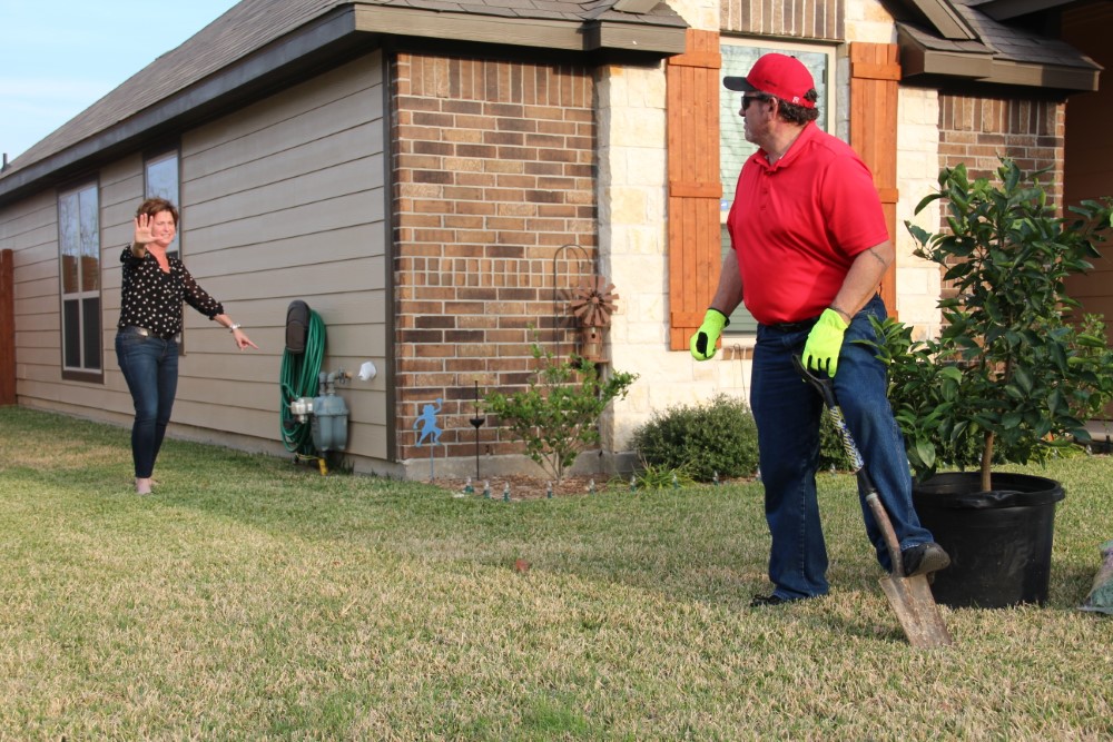 Call before you dig - Woman stopping guy from digging, pointing out the gas meter on the house