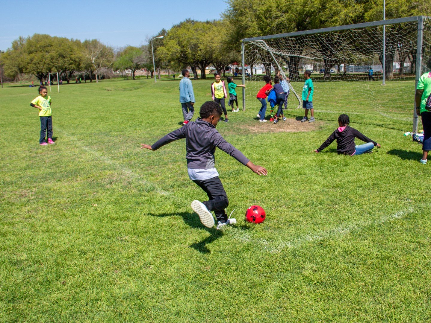 Young children playing soccer at Jackson Street Park
