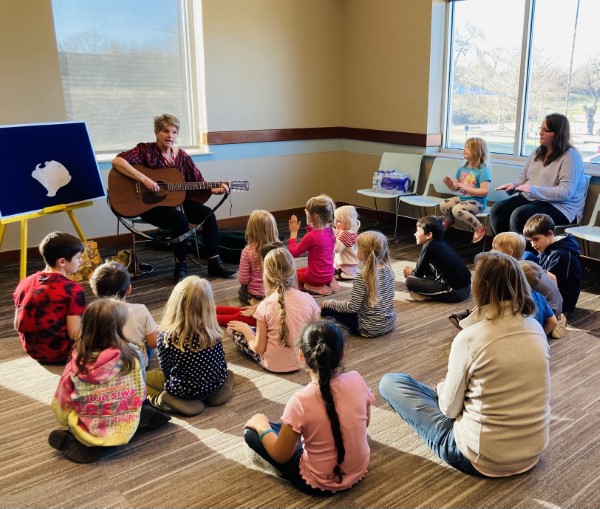 People listening to musician