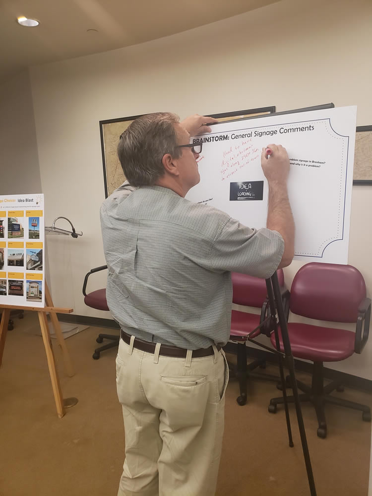 2019-sign-input-meeting-man filling out a comment board