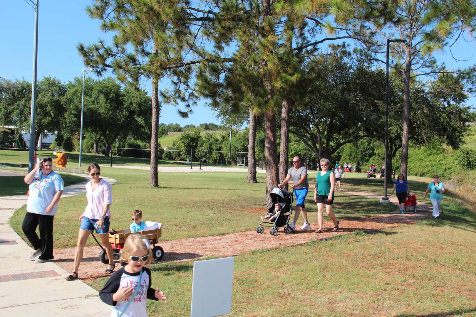 event-roll-n-read-kids in park with parents pushing strollers