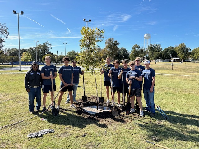 BISD baseball and softball players assisting WoodmenLlife's donation and planting a pecan tree