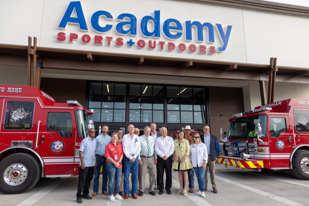Academy Sports + Outdoors store front with Washington County Commissioners and Brenham City Council members.